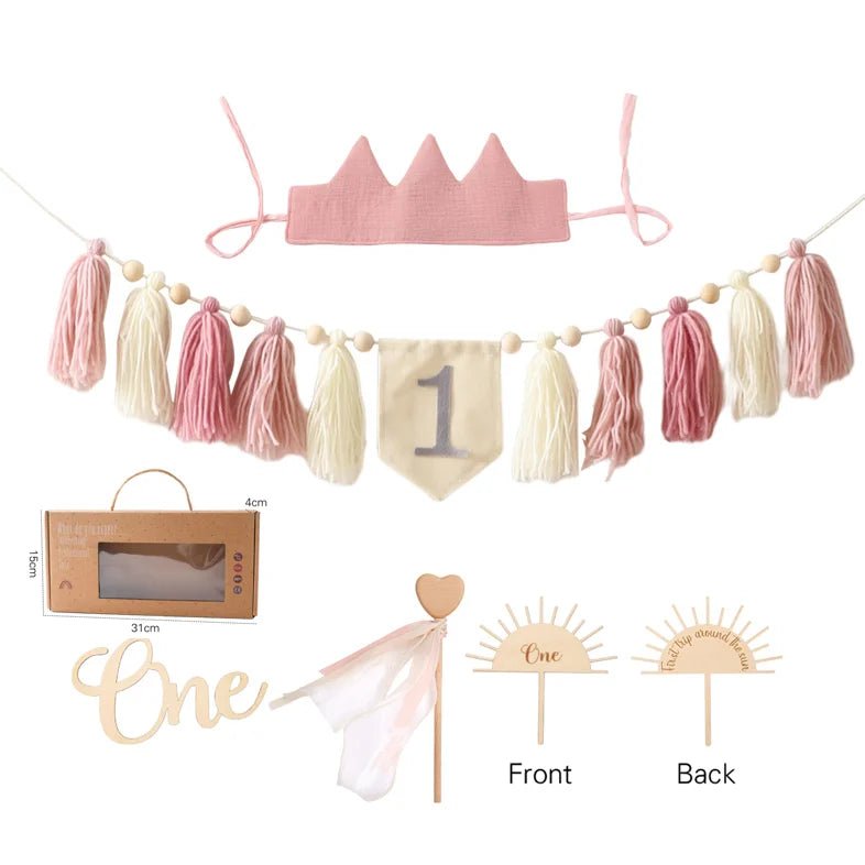 Decorative set with pink crown, tassel garland, and &