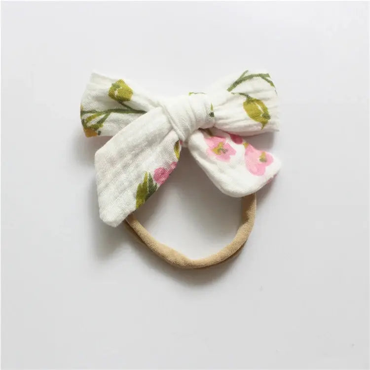 Floral bow hair tie on a white background