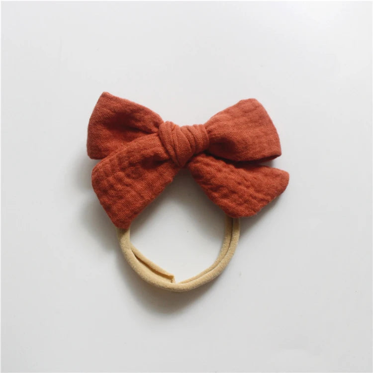 Red bow headband on a light gray background