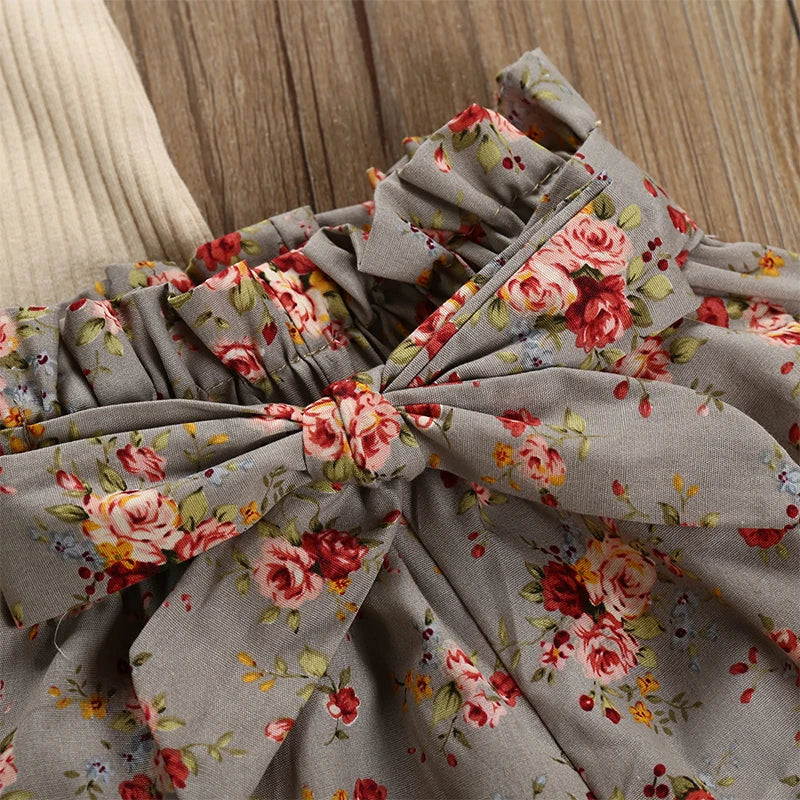 Floral fabric with a large bow on a wooden surface