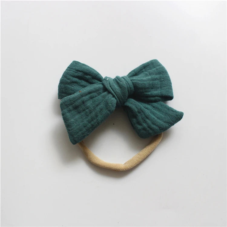 Green bow hair accessory on a white background