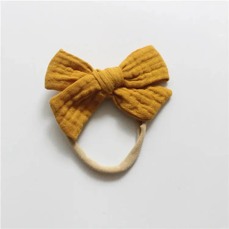 Yellow bow headband on a white background