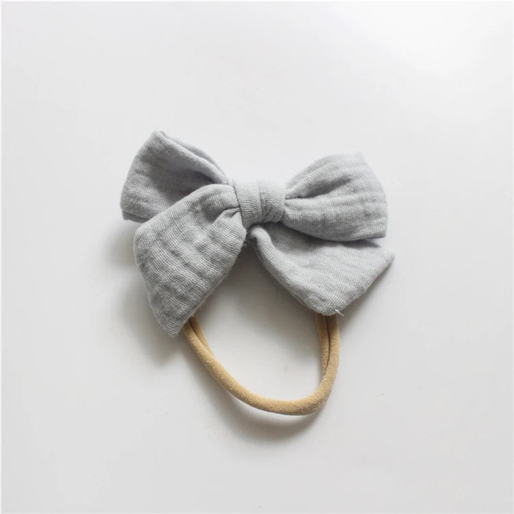 Gray bow headband on a light gray background