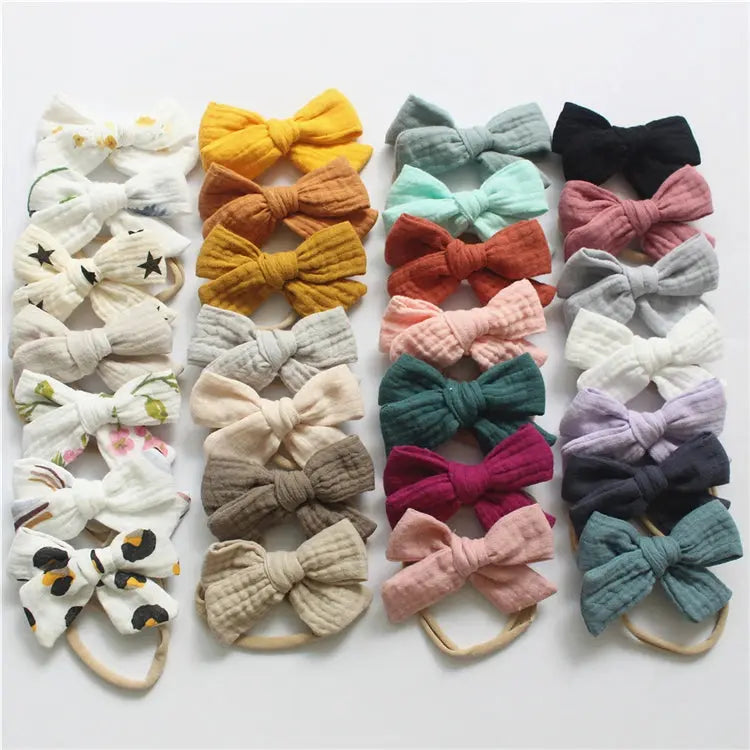 Collection of colorful baby hair bows on a white background
