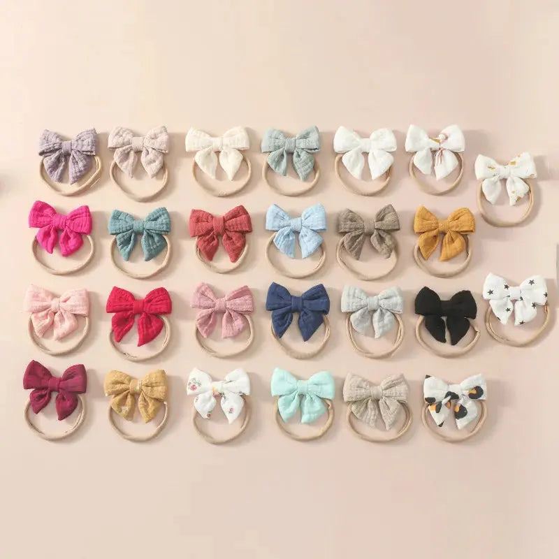 Collection of colorful bow hair ties on a beige background