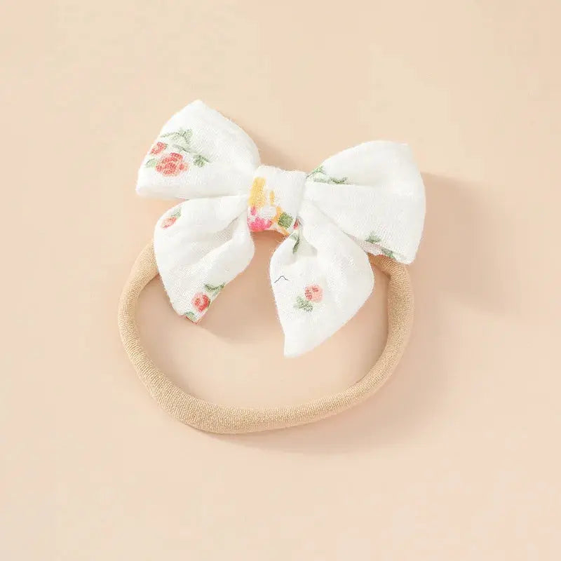 Floral bow headband on a beige background