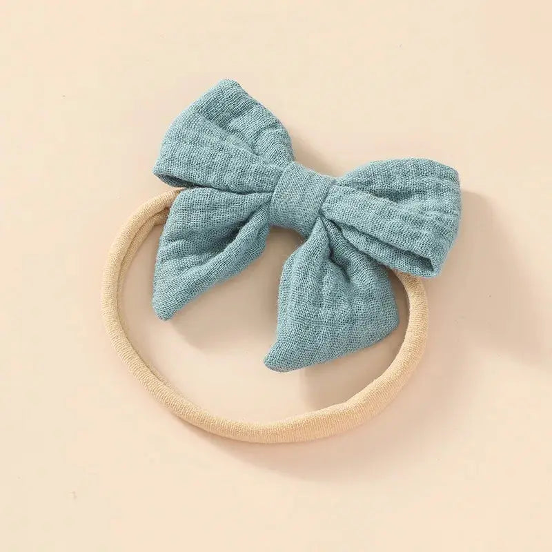 Blue bow headband on a beige background