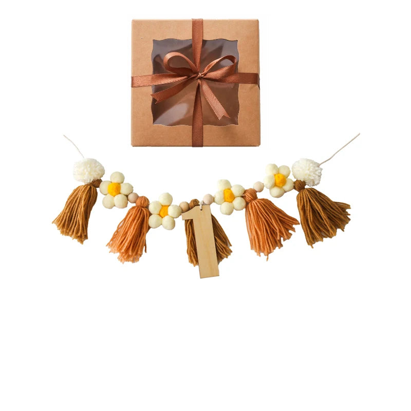Gift box with brown ribbon and tassel garland on a white background