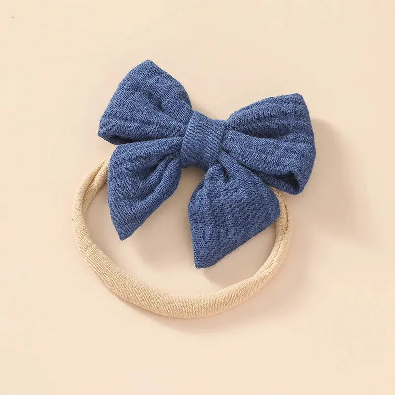 Blue bow headband on a beige background