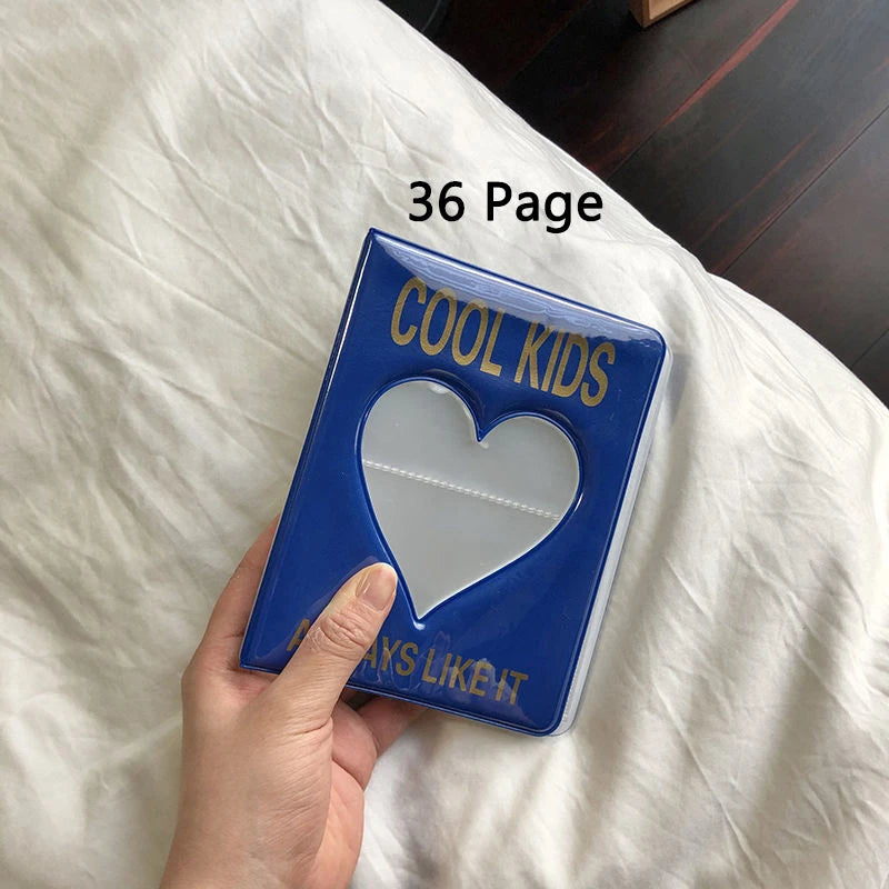 Blue book titled 'Cool Kids' with a heart cutout held by a hand on a white surface.