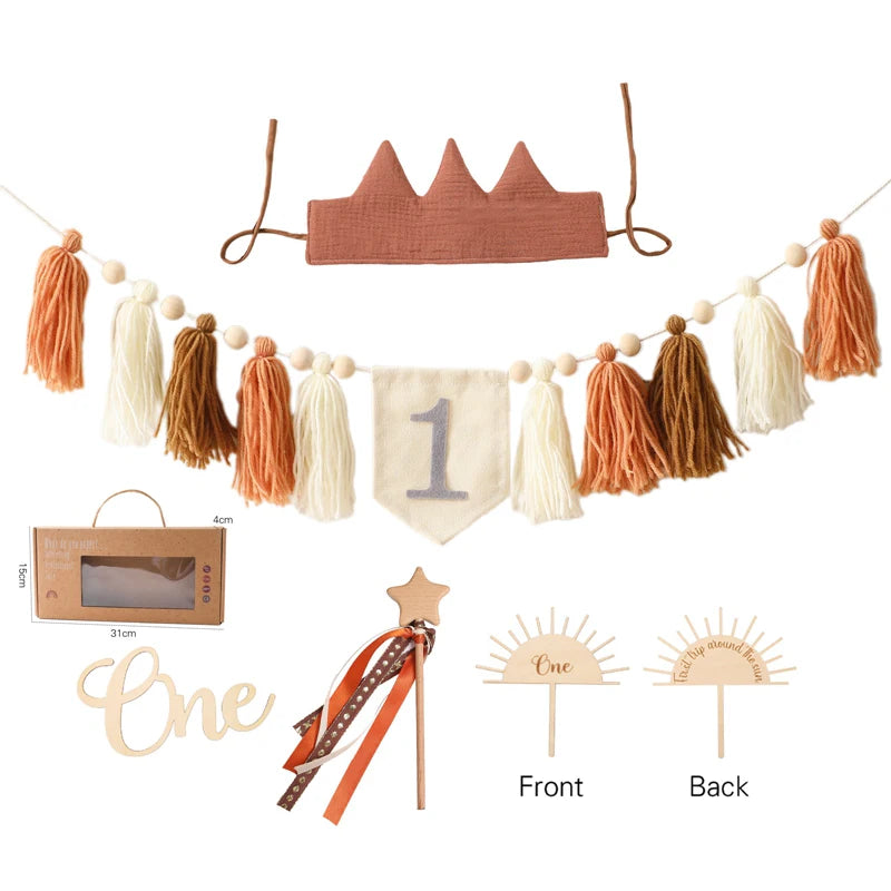 Collection of decorative items including a crown, tassel garland, and 'One' banner on a white background.