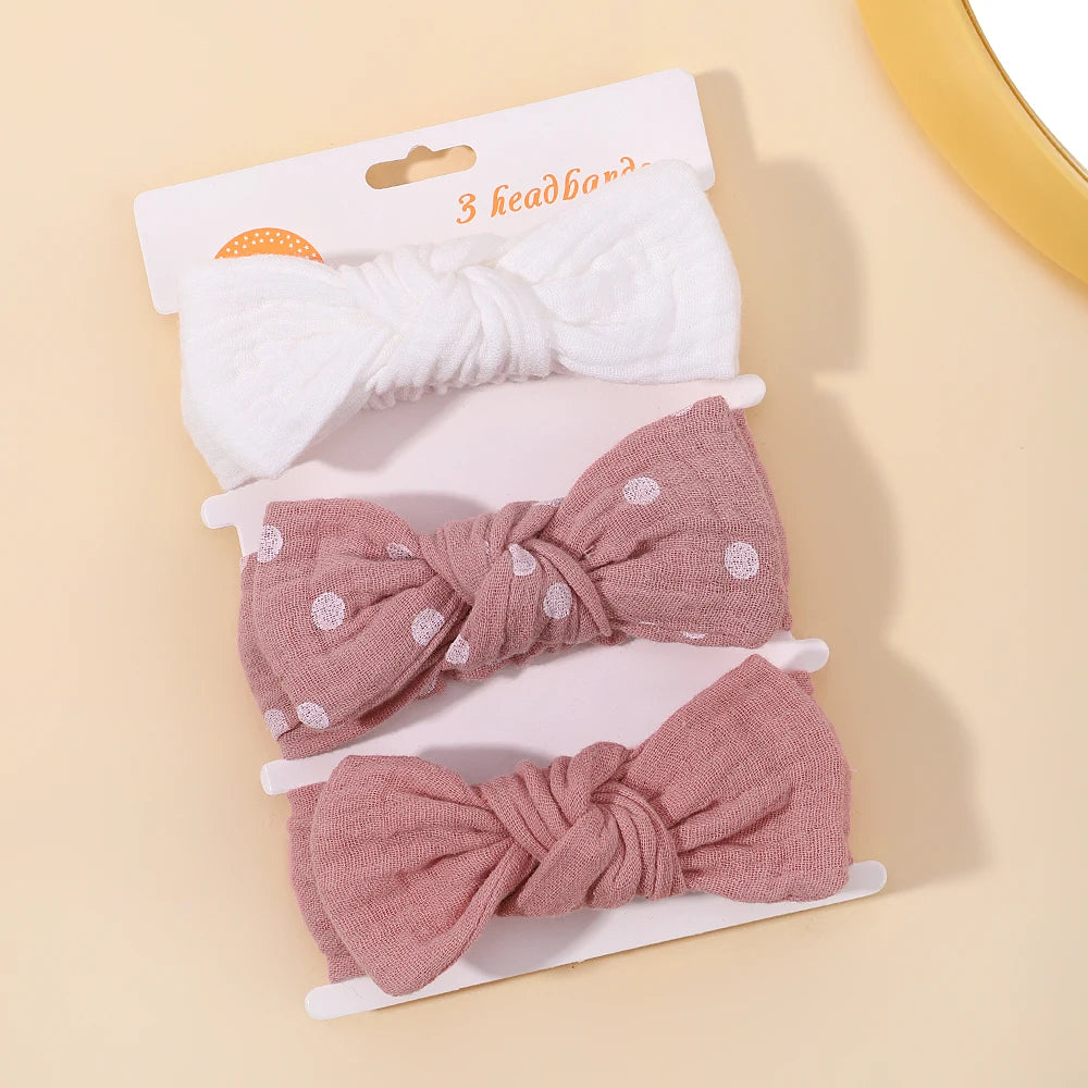 Set of three headbands with different designs on a beige background