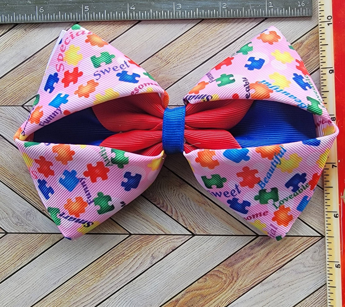 Colorful bow with puzzle piece pattern on a wooden surface with a ruler for scale.