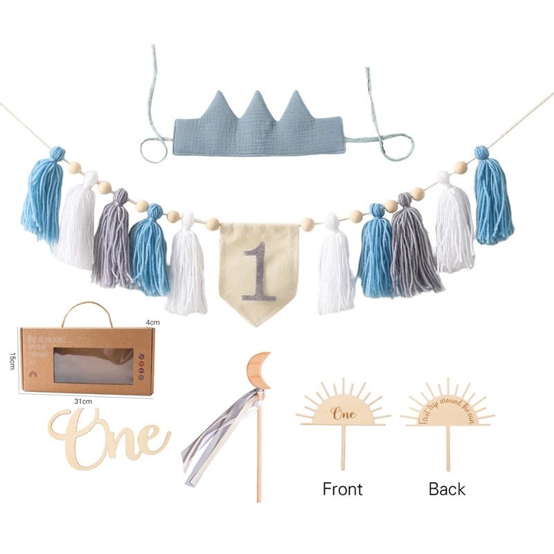 Collection of baby-themed decorative items including a crown, tassel garland, and &