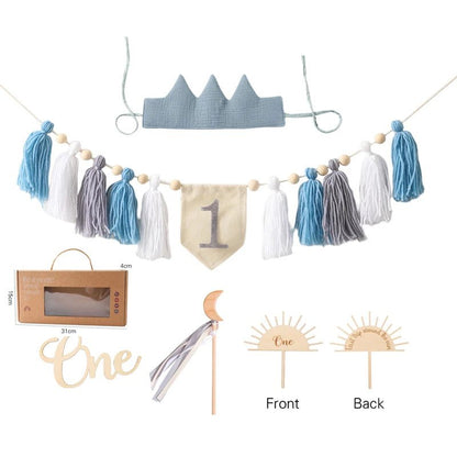 Collection of baby-themed decorative items including a crown, tassel garland, and &