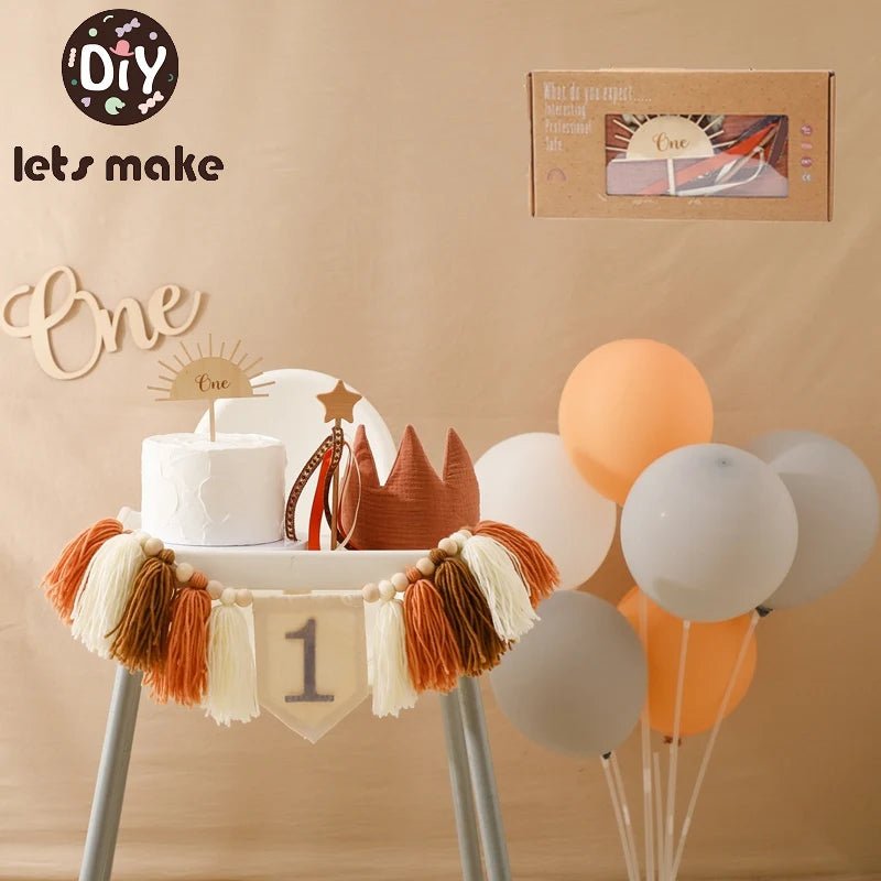 First birthday setup with cake, balloons, and decorations on a stand against a beige background.
