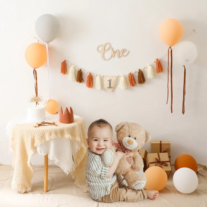 Child with teddy bear in a decorated room with balloons and &
