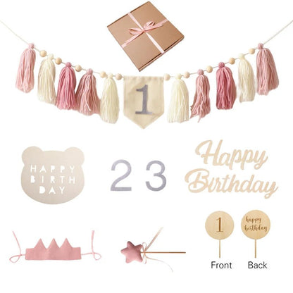 Collection of birthday-themed decorations including a tassel banner, number flags, and cake toppers on a white background.