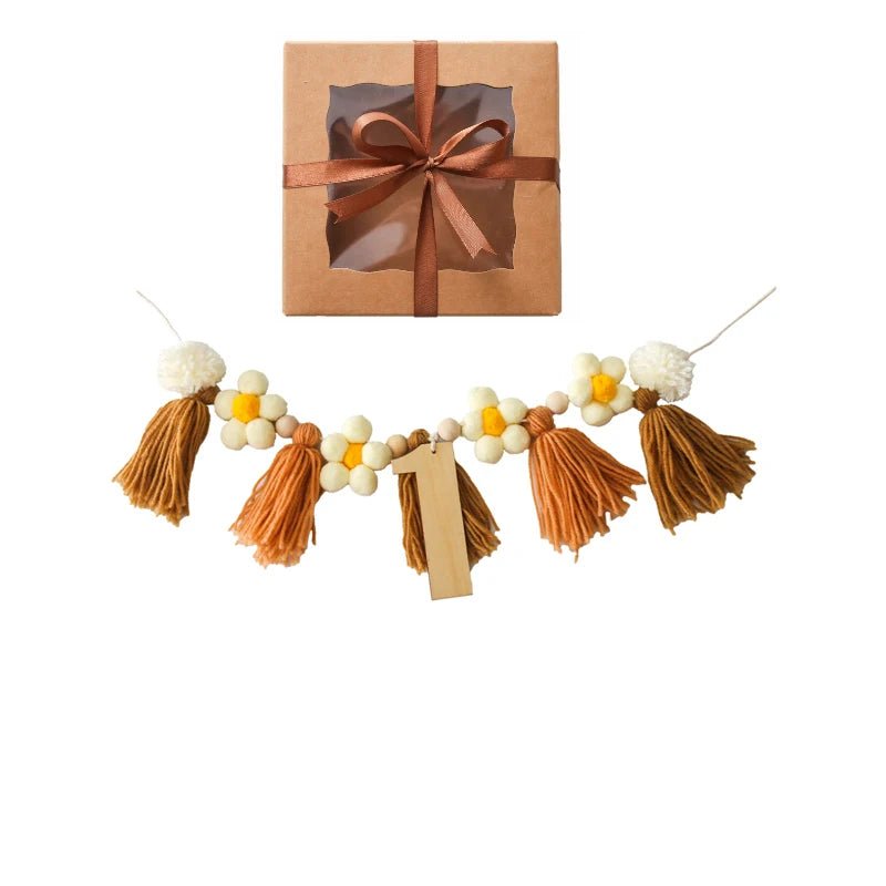 Gift box with brown ribbon and tassel garland on a white background