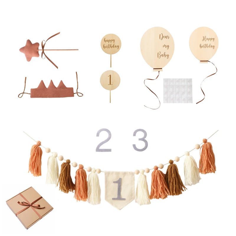 Collection of birthday-themed decorations including a star, crown, balloons, numbers, and tassel garland.