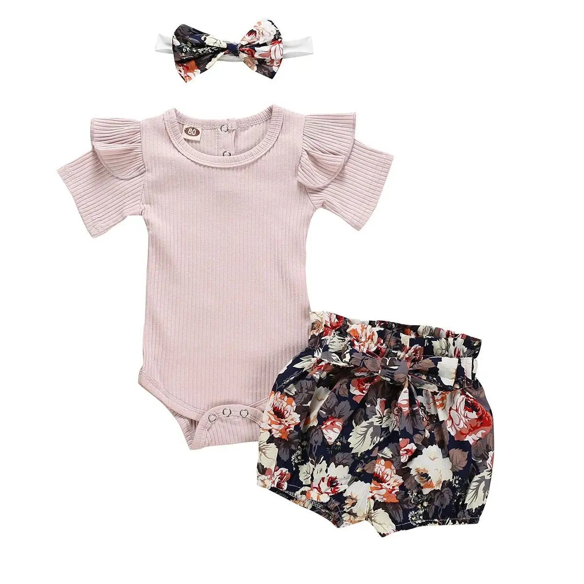 Baby outfit set with pink romper, floral bloomers, and headband on a white background