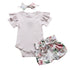 Baby outfit set with ruffled onesie, floral shorts, and headband on a white background