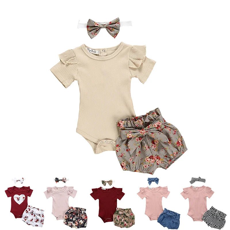 Baby outfit set with beige romper, floral shorts, and headband on a white background.