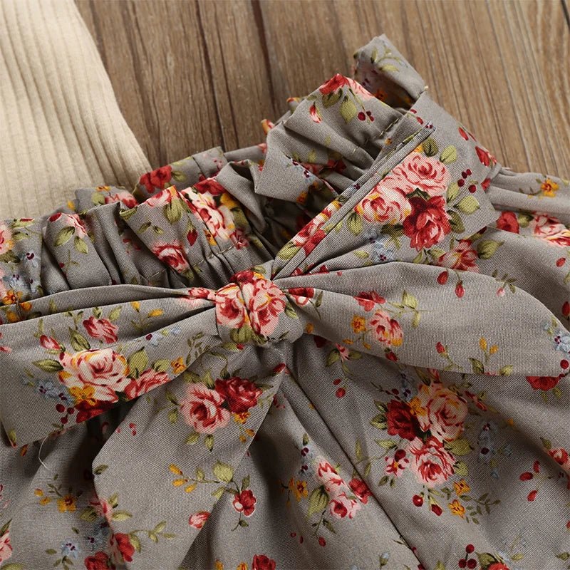 Floral fabric with a large bow on a wooden surface