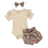 Baby outfit set with beige romper, floral bloomers, and headband on a white background