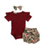 Baby outfit set with red romper, floral bloomers, and headband on a white background