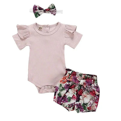Baby outfit set with pink romper, floral bloomers, and headband on a white background