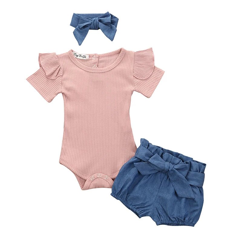 Baby outfit set with pink romper, blue bloomers, and headband on a white background