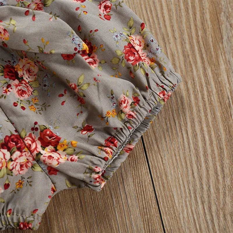 Floral-patterned pants on a wooden floor