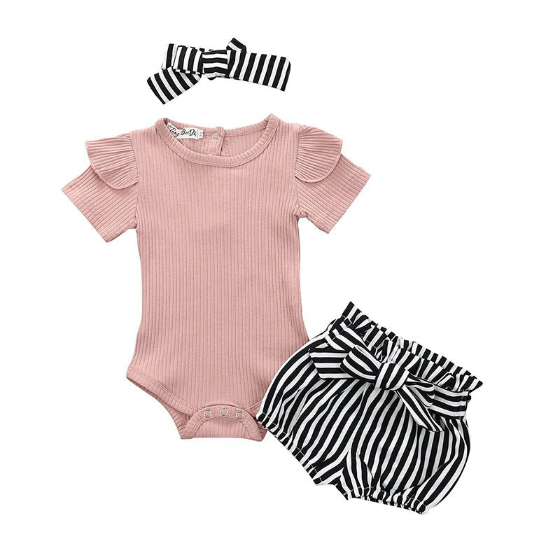 Baby outfit set with pink bodysuit, striped shorts, and headband on a white background