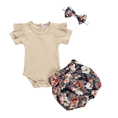 Baby outfit set with beige onesie, floral bloomers, and headband on a white background