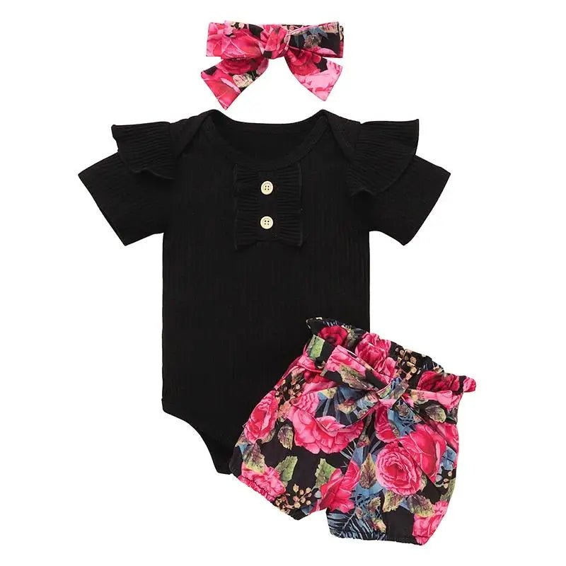Black baby romper with floral bloomers and headband on a white background