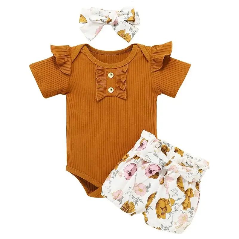 Baby outfit set with rust-colored romper, floral bloomers, and matching headband on a white background.