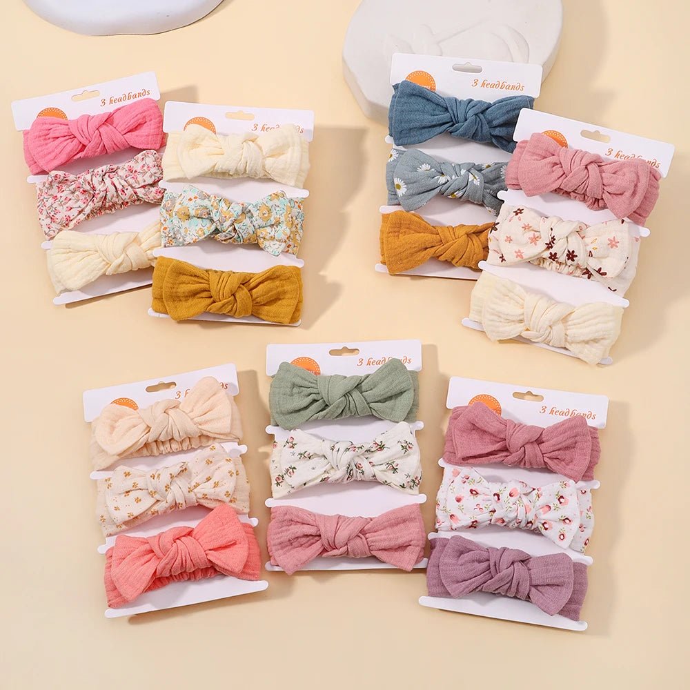 Assorted colorful hair bows on display with packaging on a beige background