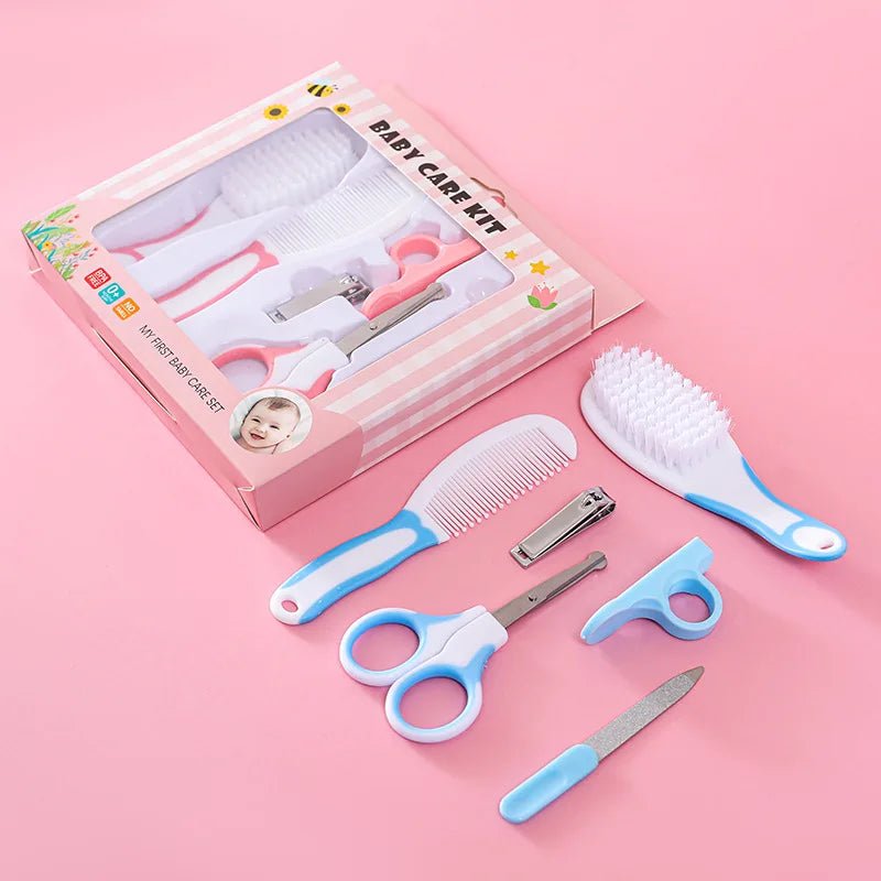 Baby pedicure care kit with a pink striped box and five tools arranged on a pink background: a comb, nail clipper, cuticle tool, nail file, and brush.