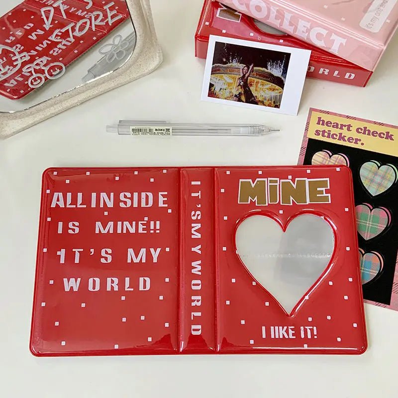 Red card with text and heart design on a white surface with other items.