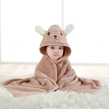Baby wrapped in a brown hooded towel with bunny ears on a white background