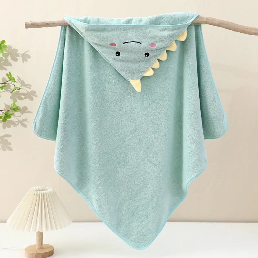 Light blue hooded towel with shark design on a wooden stick against a neutral background