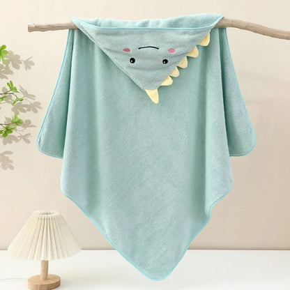 Light blue hooded towel with shark design on a wooden stick against a neutral background