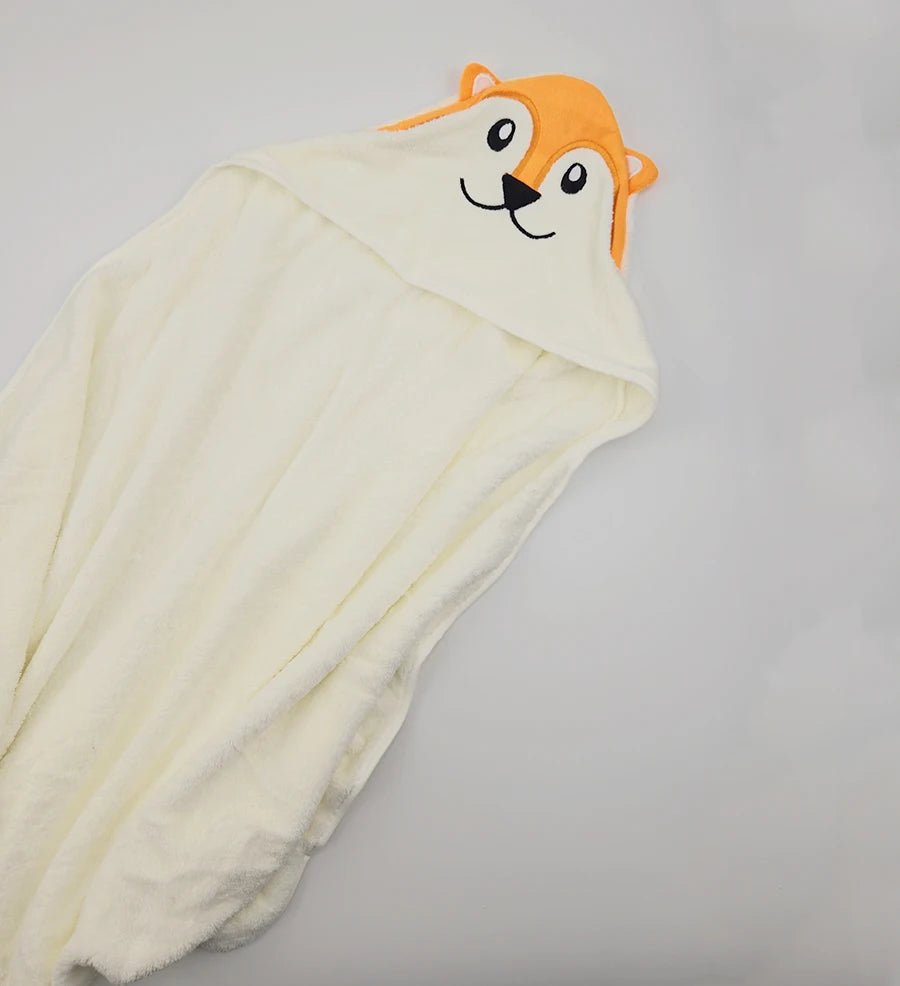 White hooded towel with a cartoon dog face on a gray background