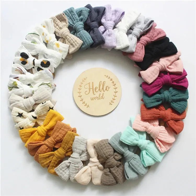 Colorful collection of hair accessories arranged in a circular wreath on a white background with 'Hello world' sign.