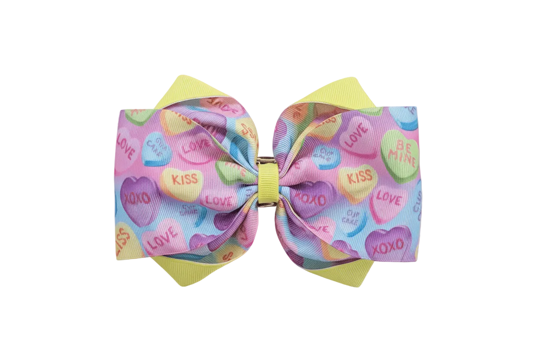 Hero image of pastel candy hearts hair bow on dreamy Valentine&