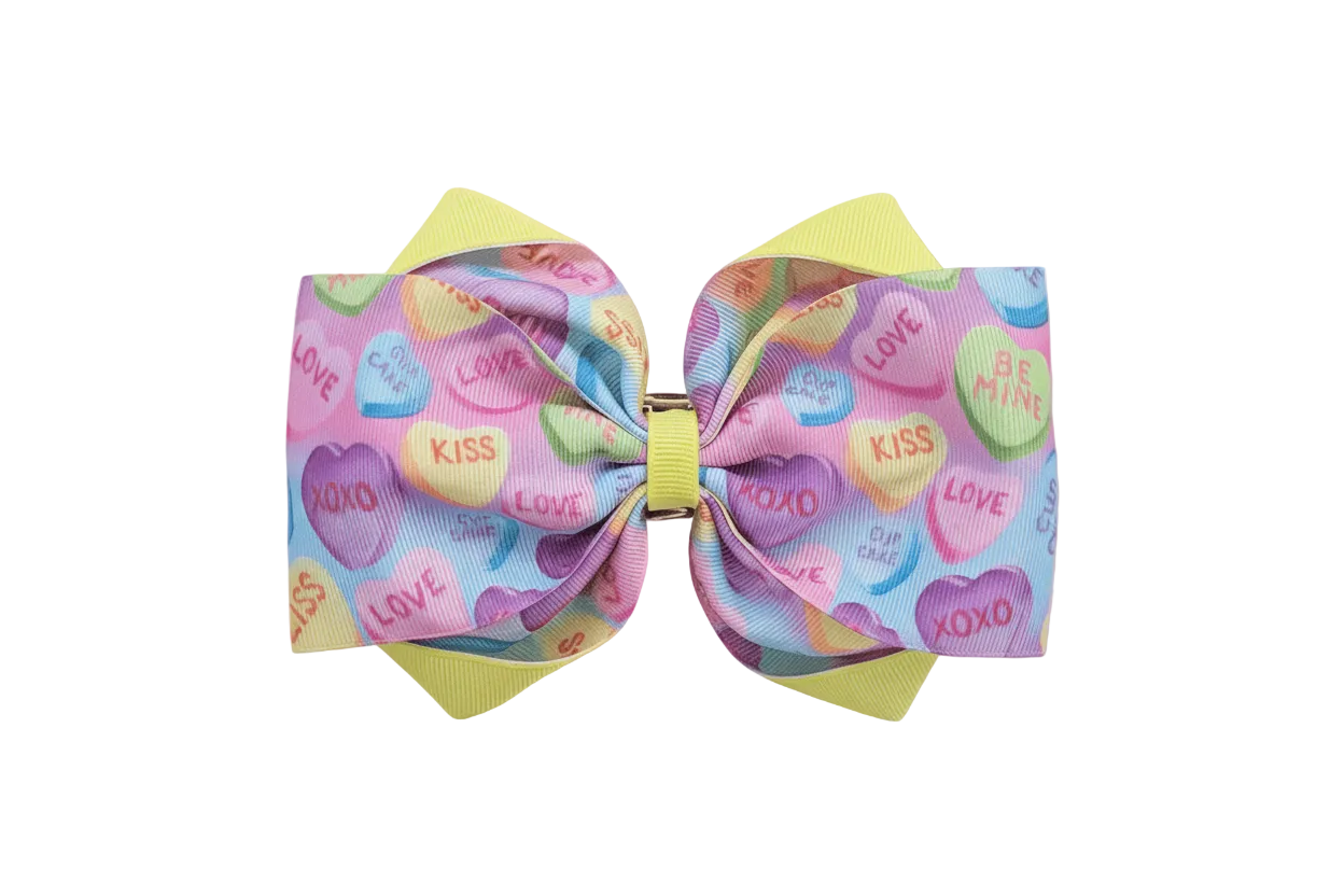 Hero image of pastel candy hearts hair bow on dreamy Valentine&