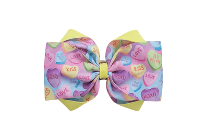 Hero image of pastel candy hearts hair bow on dreamy Valentine&