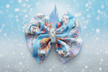 Hero image of Cinderella hair bow on dreamy fairytale background with castle silhouette and magical sparkles
