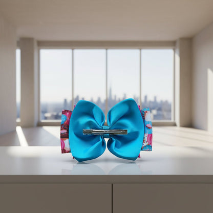 A bright turquoise blue grosgrain ribbon hair bow with a silver metal clip.